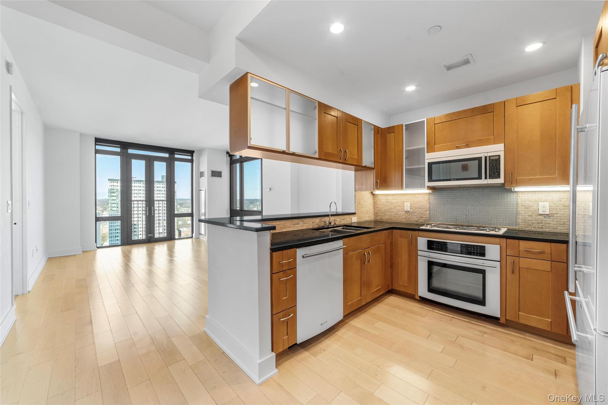 a kitchen with stainless steel appliances granite countertop a stove and a refrigerator