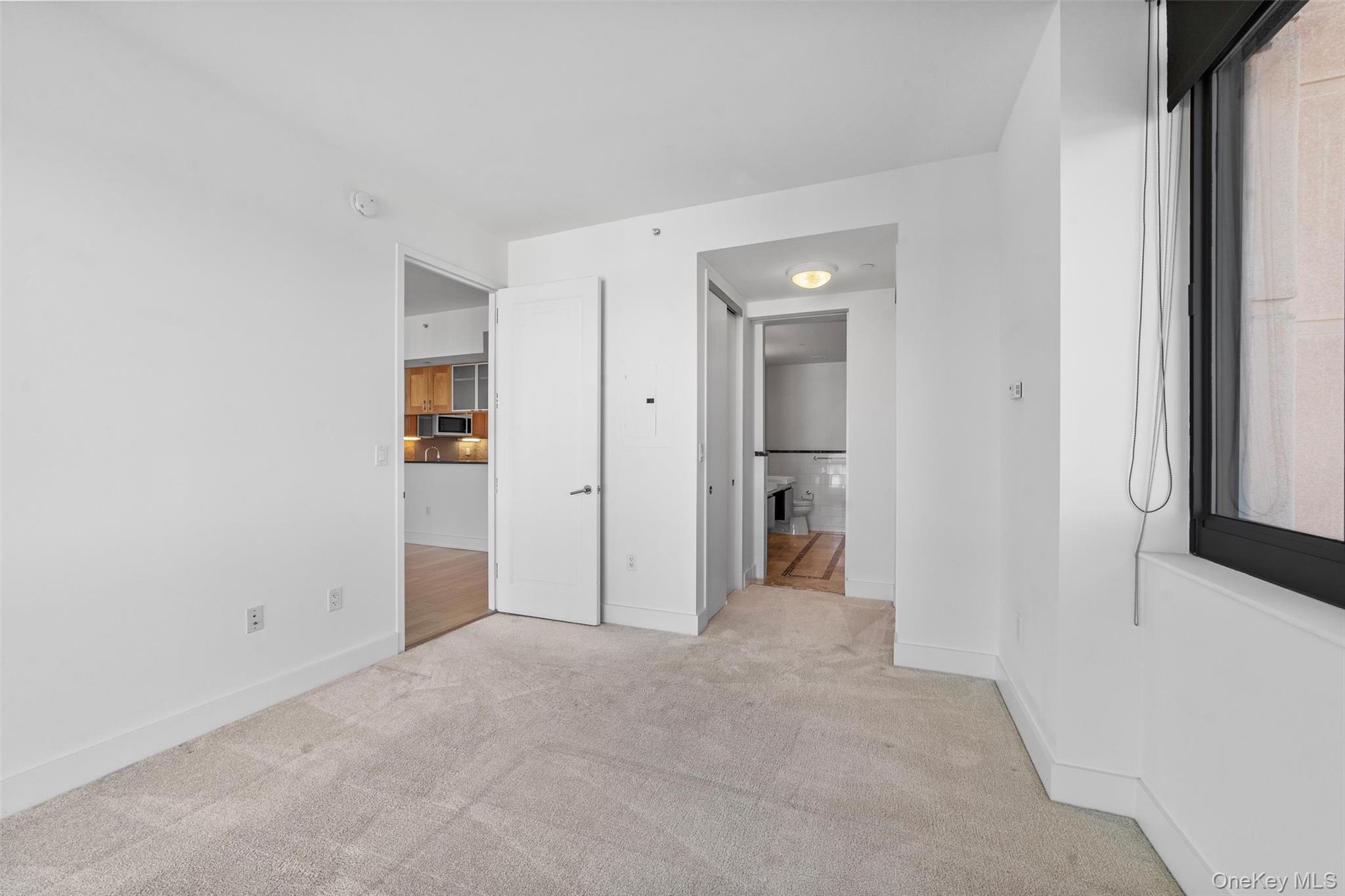 175 Huguenot Street, Unit 2108 New Rochelle, NY 10801 - Photo 12 of 18 an empty room with a natural light