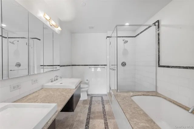 a bathroom with a tub sink and shower