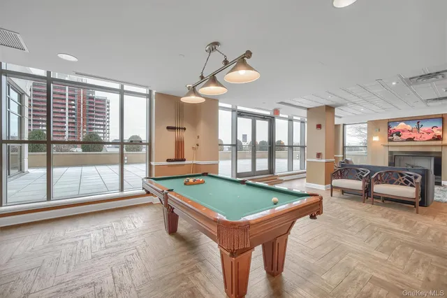 a room with pool table and windows
