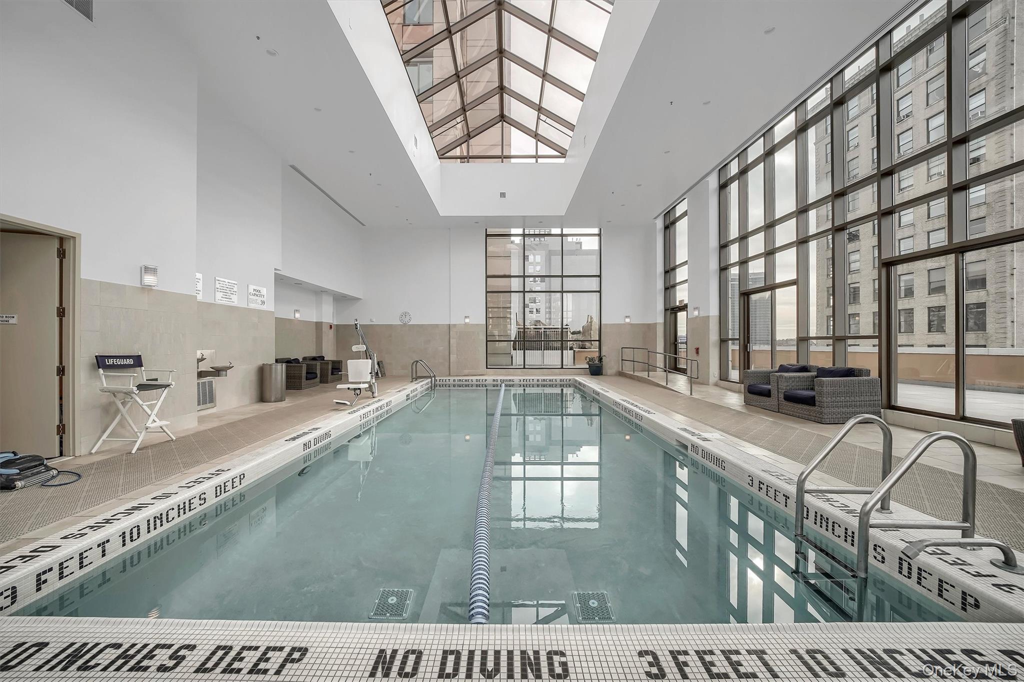 175 Huguenot Street, Unit 2108 New Rochelle, NY 10801 - Photo 18 of 18 a large white kitchen with a large window
