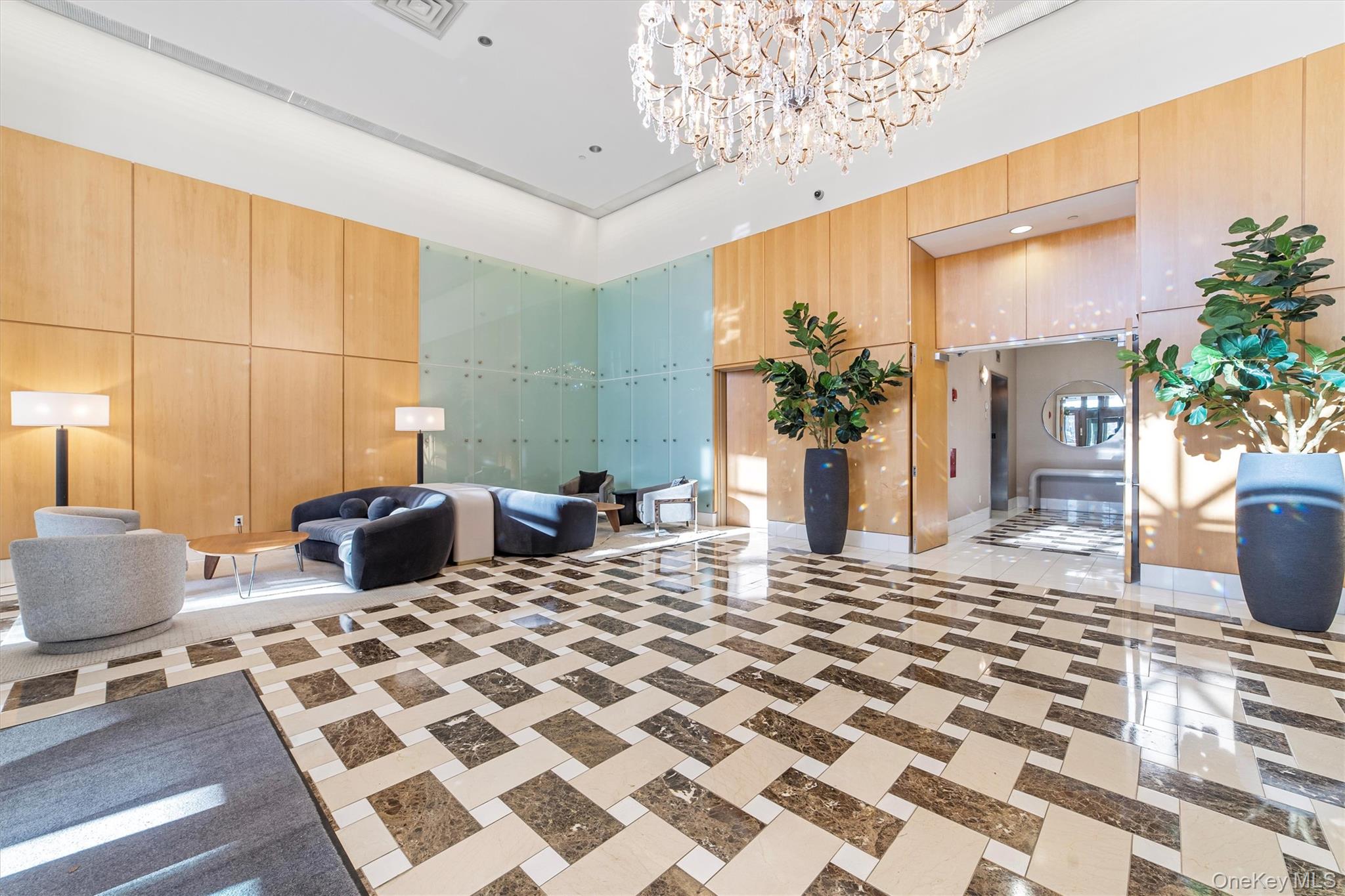 175 Huguenot Street, Unit 2108 New Rochelle, NY 10801 - Photo 3 of 18 a view of a livingroom with furniture and front door