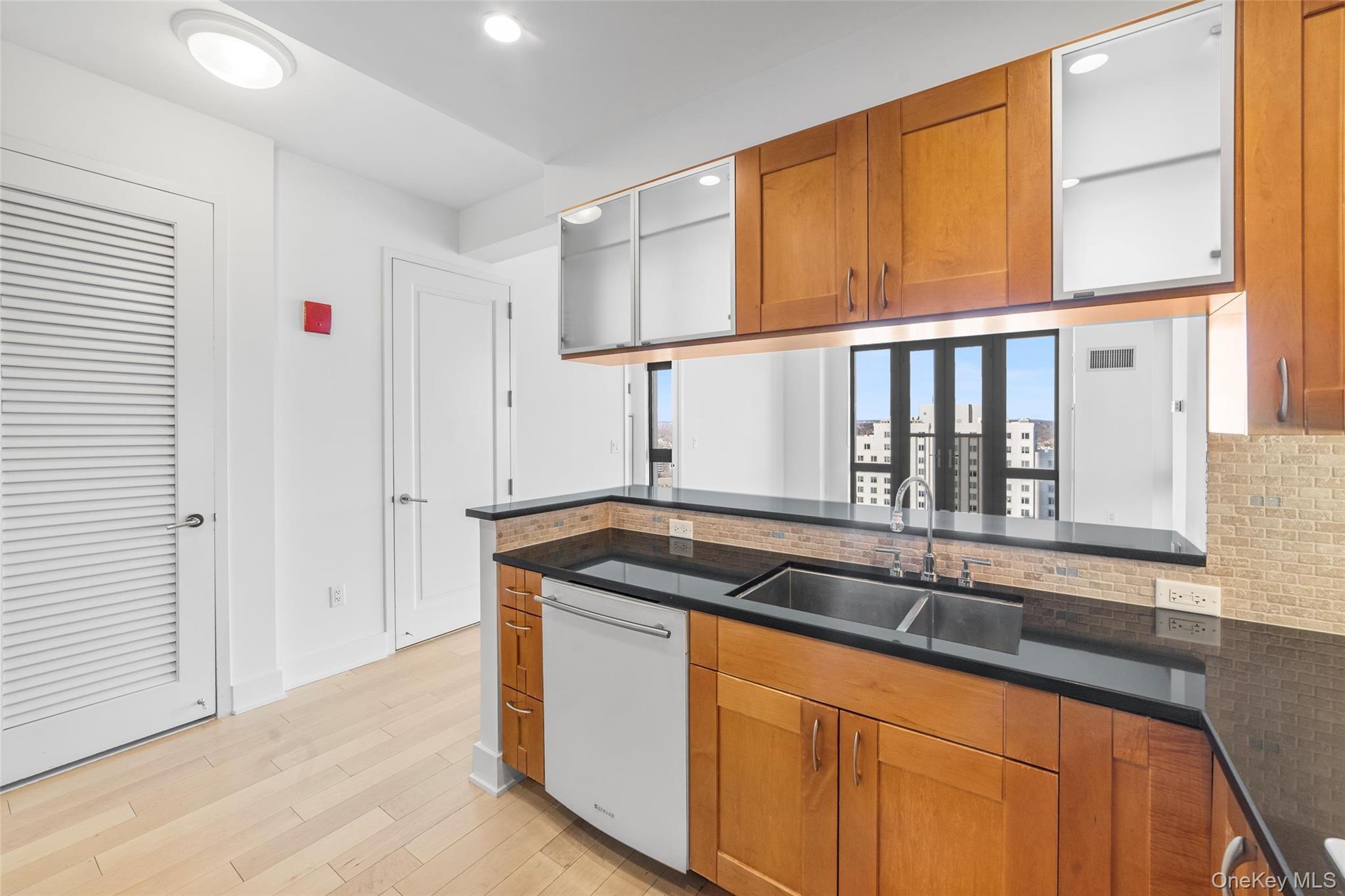 175 Huguenot Street, Unit 2108 New Rochelle, NY 10801 - Photo 5 of 18 a kitchen that has a sink and a window