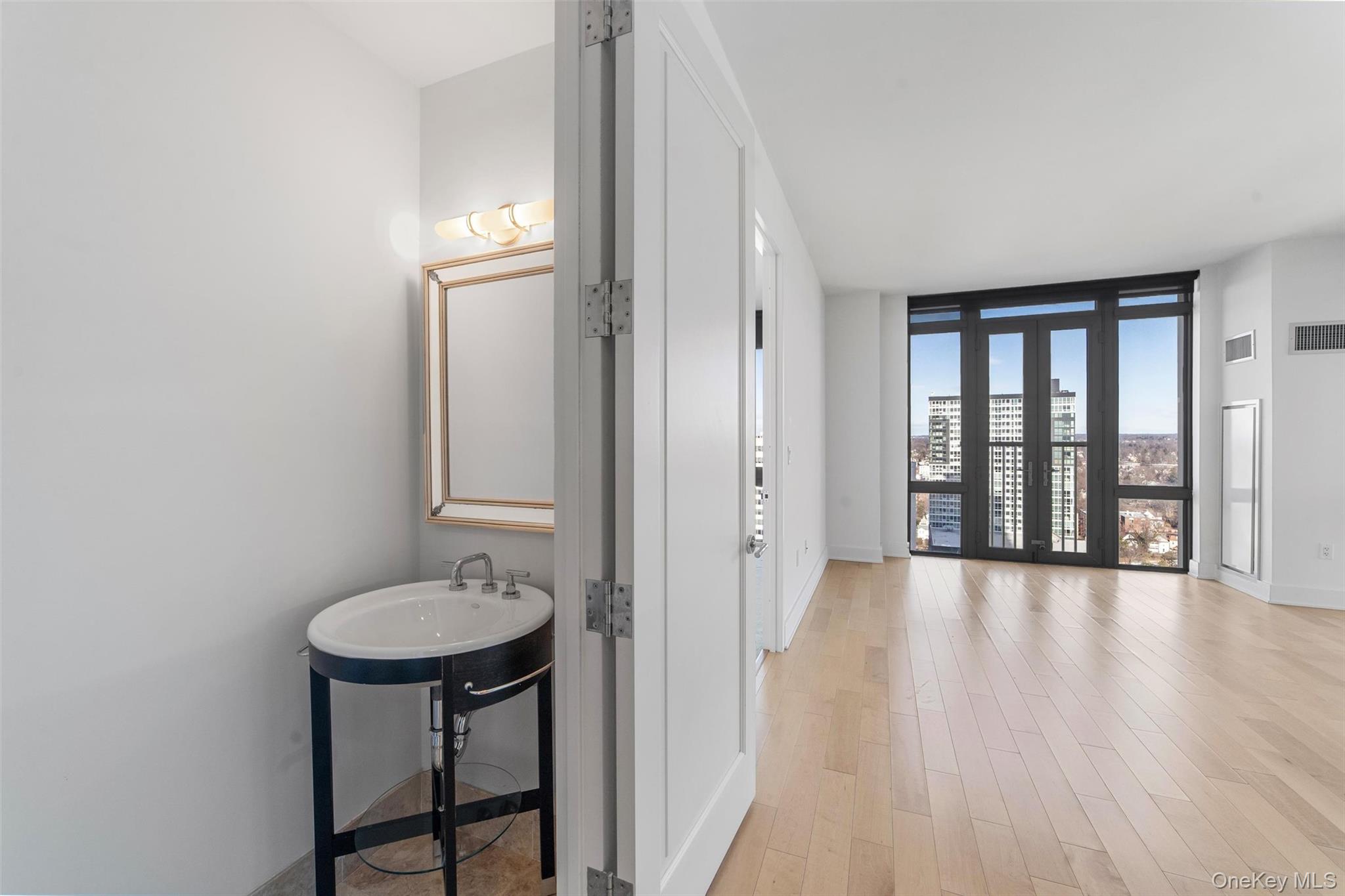 175 Huguenot Street, Unit 2108 New Rochelle, NY 10801 - Photo 9 of 18 a bathroom with a sink and a mirror
