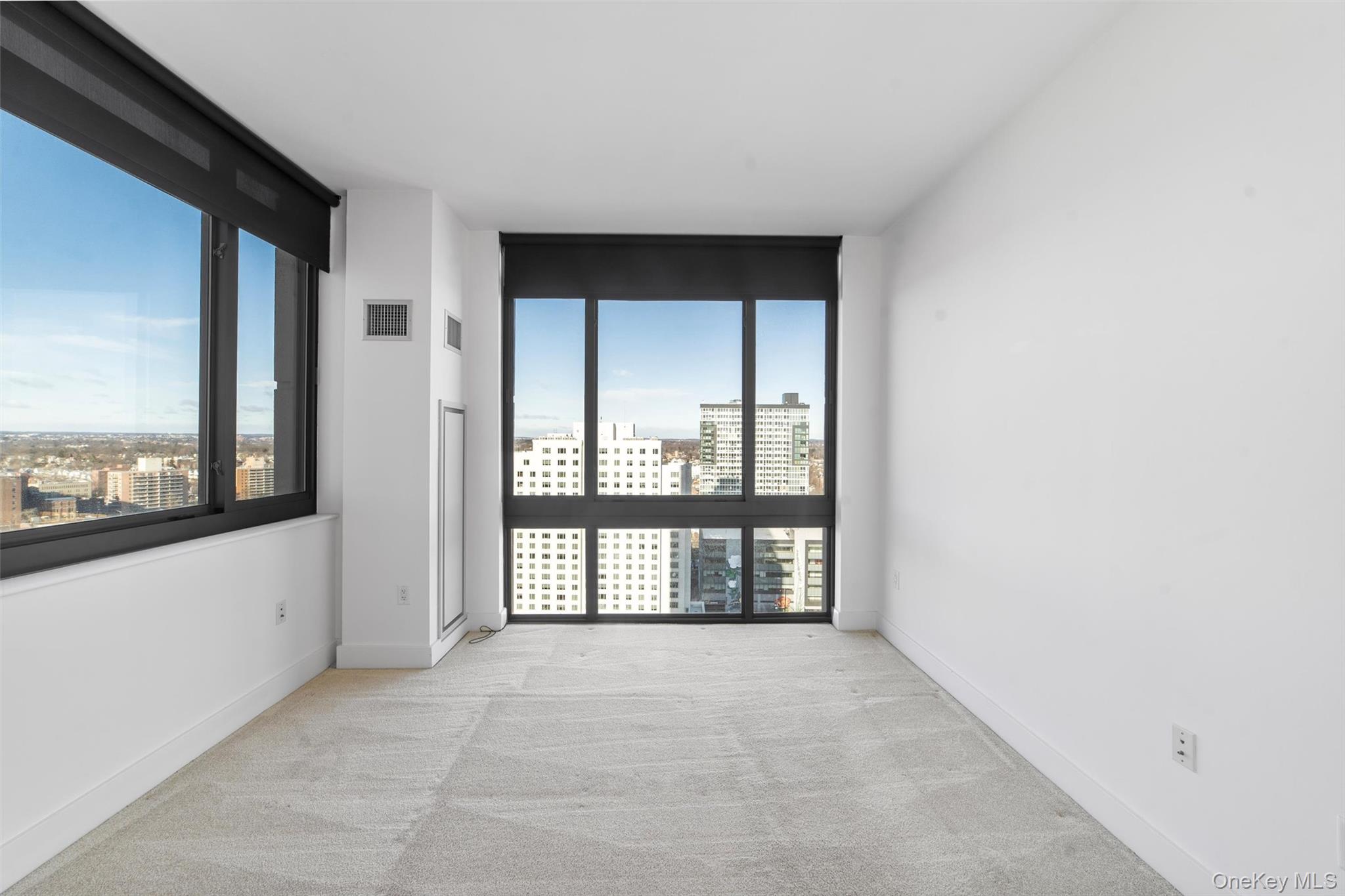 175 Huguenot Street, Unit 2108 New Rochelle, NY 10801 - Photo 10 of 18 a view of an empty room with a window