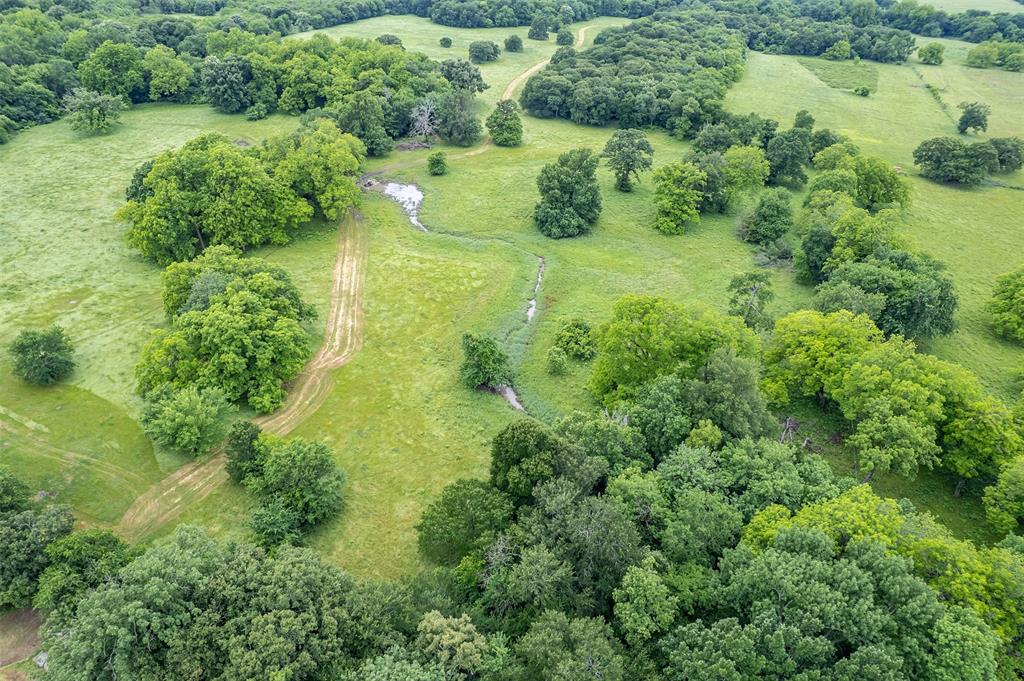 5286 County Road 4502 Commerce, TX 75428 - Photo 1 of 21 an aerial view of residential houses with outdoor space and trees all around