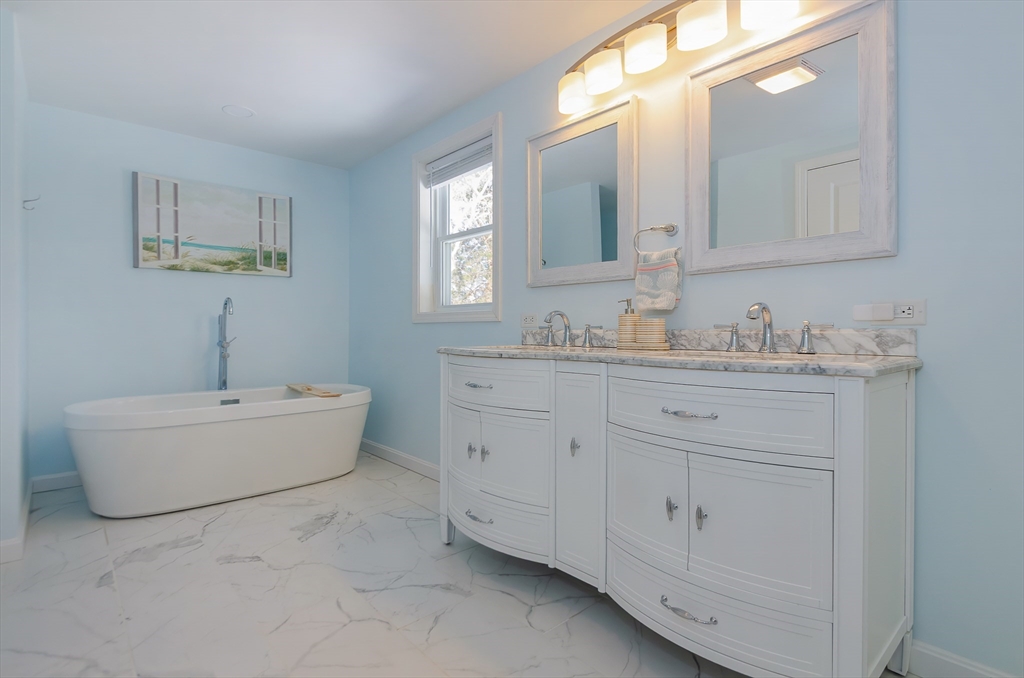 56 Acushnet Road Mattapoisett, MA 02739 - Photo 11 of 23 a bathroom with a sink double vanity granite tub and a mirror