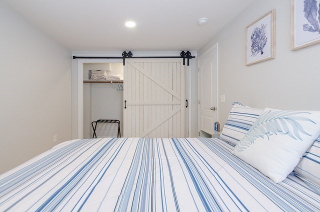 56 Acushnet Road Mattapoisett, MA 02739 - Photo 14 of 23 a bedroom with a bed and a walk in closet