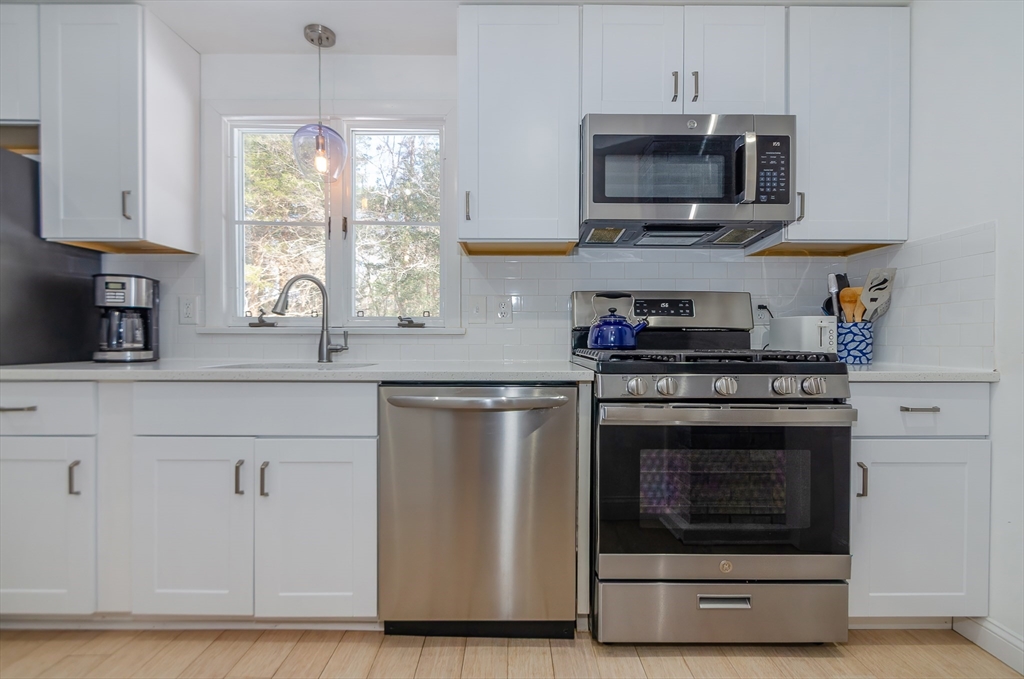 56 Acushnet Road Mattapoisett, MA 02739 - Photo 2 of 23 a kitchen with stainless steel appliances granite countertop a stove microwave and sink