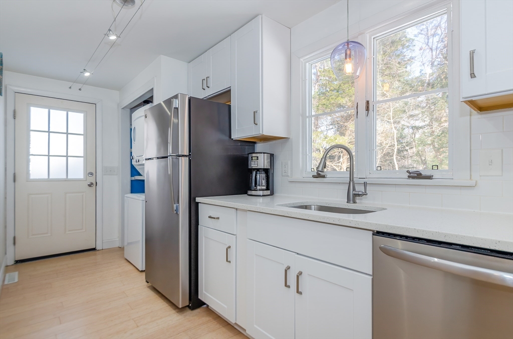 56 Acushnet Road Mattapoisett, MA 02739 - Photo 4 of 23 a kitchen with appliances cabinets and a sink