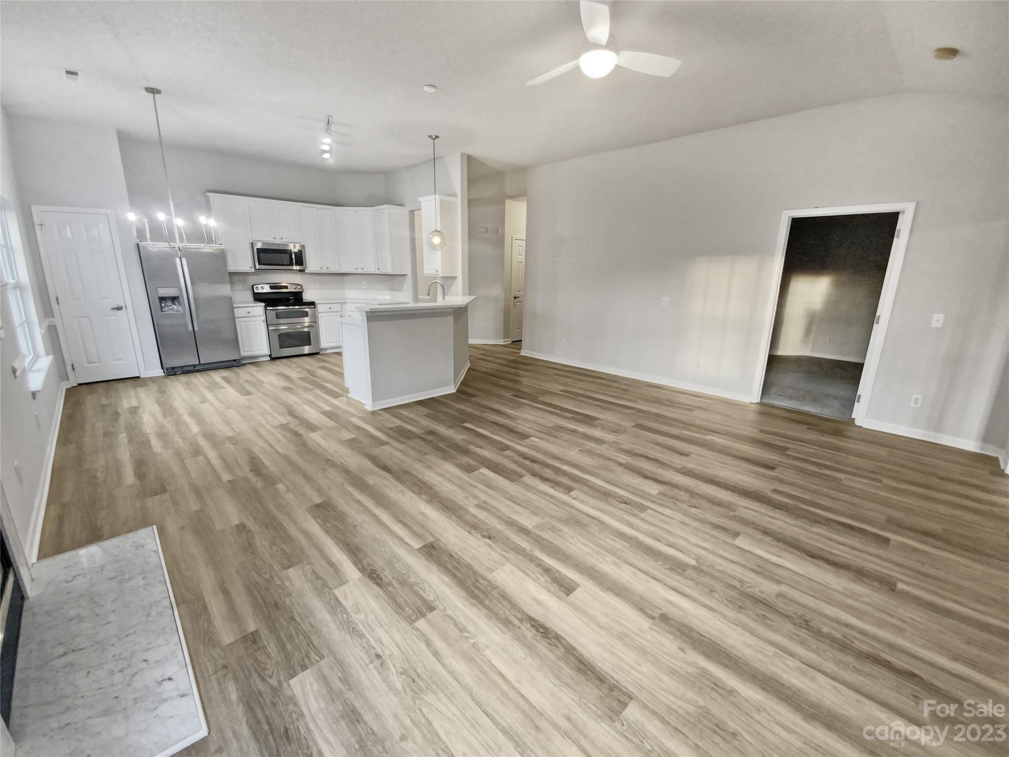 6710 Reedy Creek Road Charlotte, NC 28215 - Photo 17 of 26 a view of kitchen with refrigerator stove and wooden floor