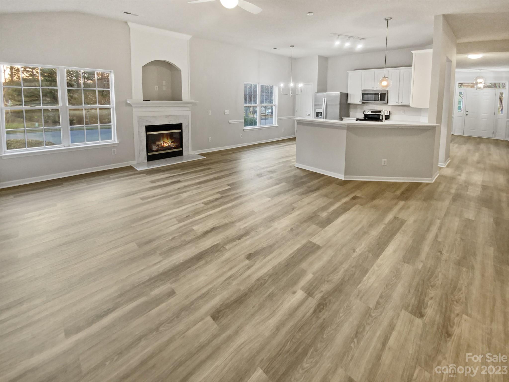 6710 Reedy Creek Road Charlotte, NC 28215 - Photo 3 of 26 a view of kitchen with wooden floor and a fireplace