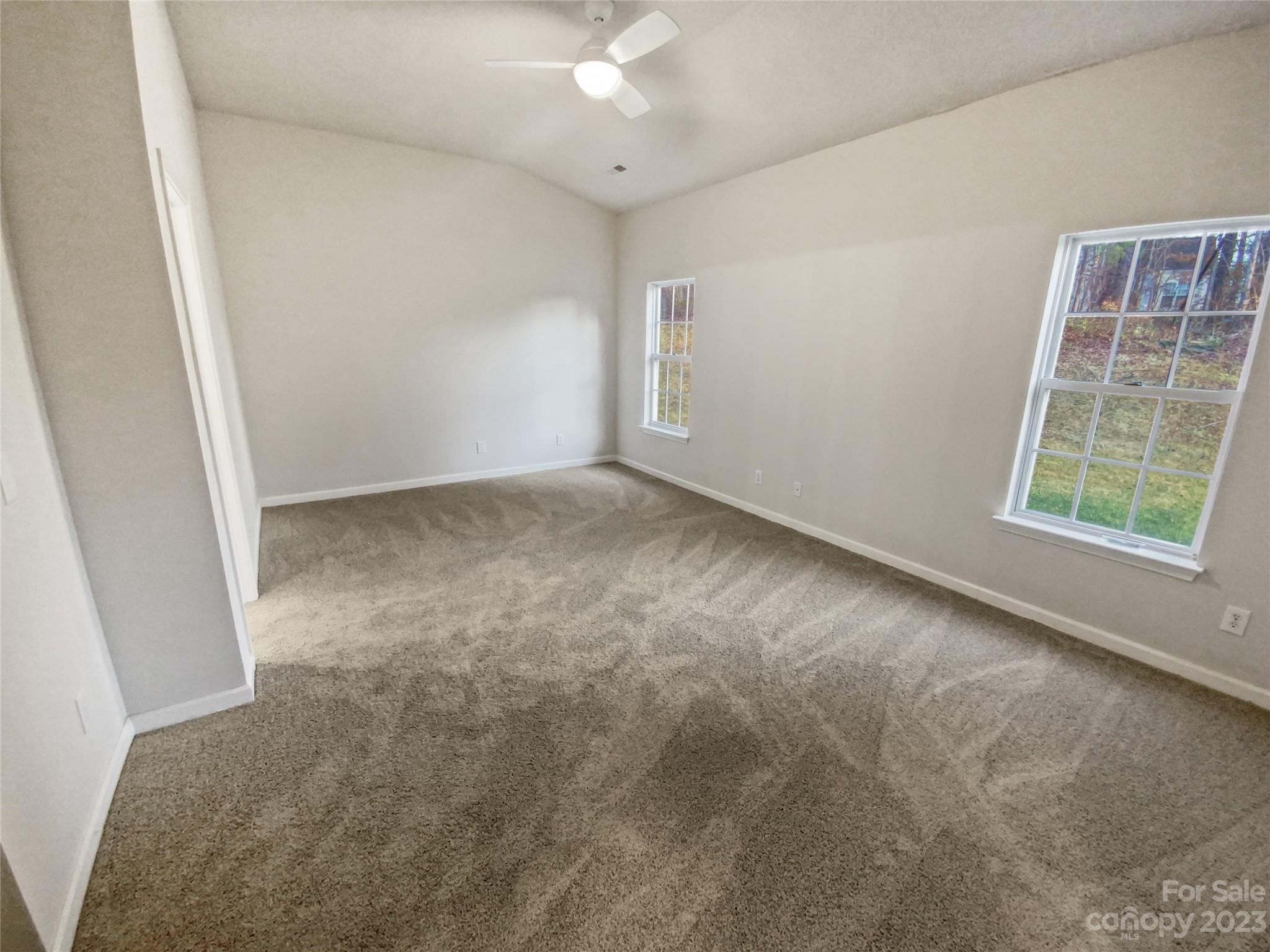6710 Reedy Creek Road Charlotte, NC 28215 - Photo 5 of 26 an empty room with windows
