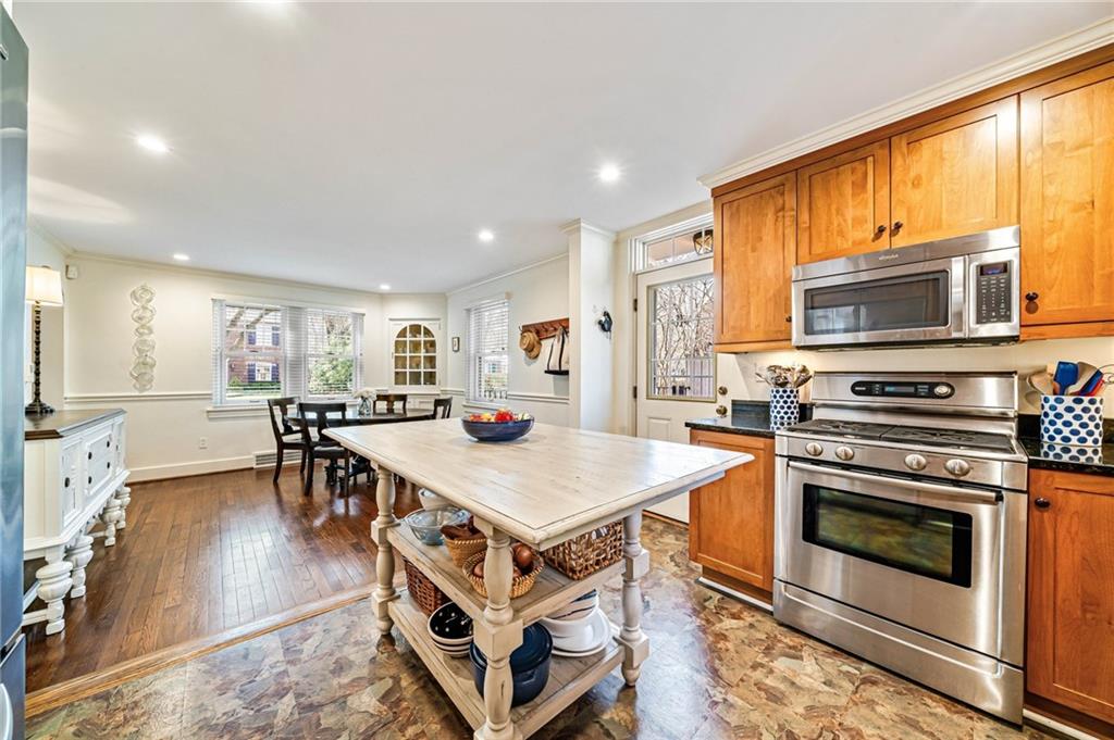 308 Maple Lane Sewickley, PA 15143 - Photo 19 of 40 a kitchen with stainless steel appliances granite countertop a stove top oven a sink dishwasher a dining table and chairs with wooden floor