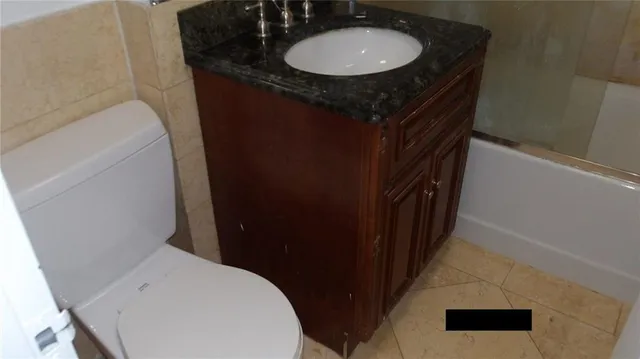 a bathroom with a double vanity sink and a toilet