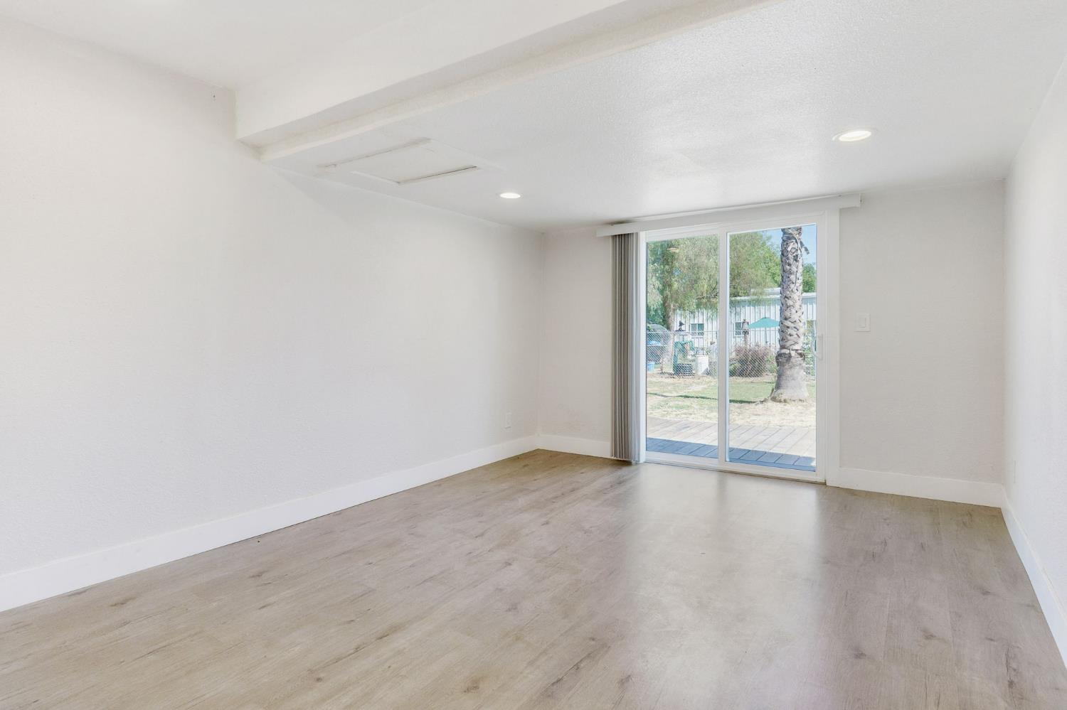 4729 Santa Rosa Avenue Robbins, CA 95676 - Photo 18 of 28 an empty room with wooden floor and windows