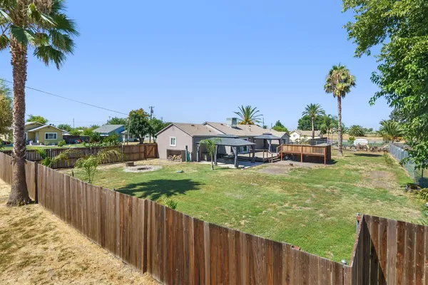 a view of a house with wooden fence