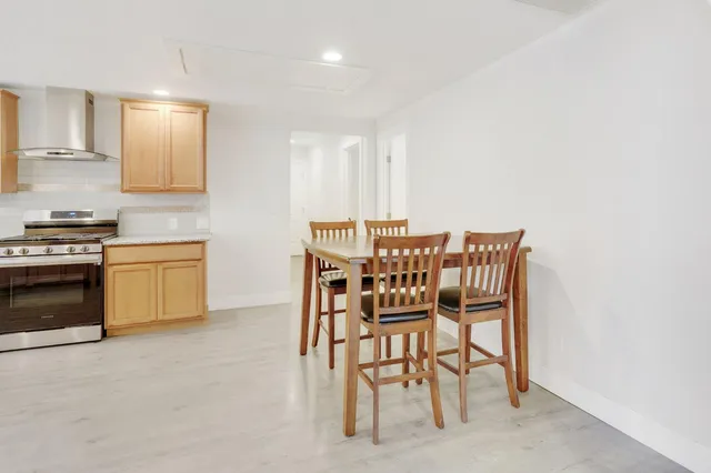 a dining room with furniture and window