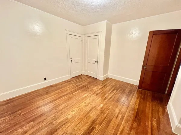 a view of a room with wooden floor and bathroom