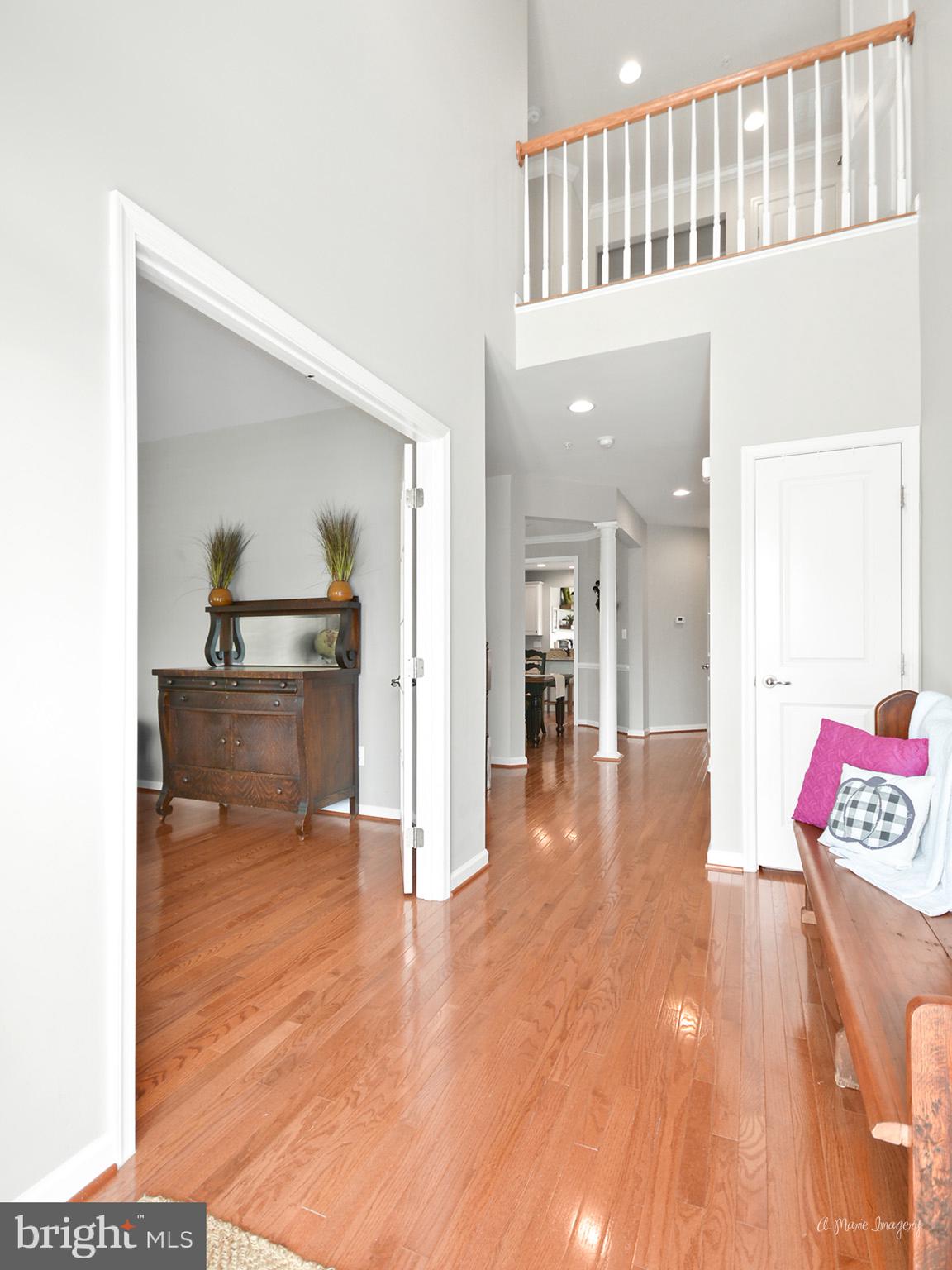 Gleaming hardwoods and a 2 story foyer welcome you