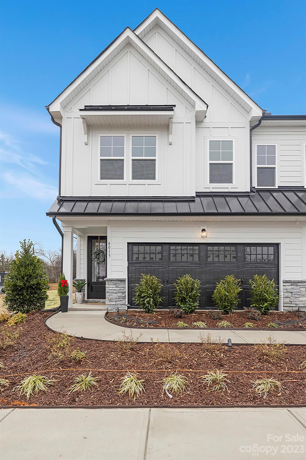 4013 Ashton Ridge Lane Charlotte, NC 28226 - Photo 1 of 13 a front view of a house with a yard and garage