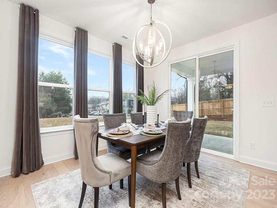4013 Ashton Ridge Lane Charlotte, NC 28226 - Photo 6 of 13 a dining room with furniture a chandelier and wooden floor