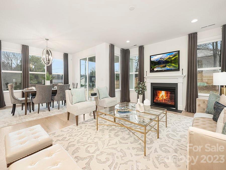 4013 Ashton Ridge Lane Charlotte, NC 28226 - Photo 8 of 13 a living room with furniture a large window and a fireplace