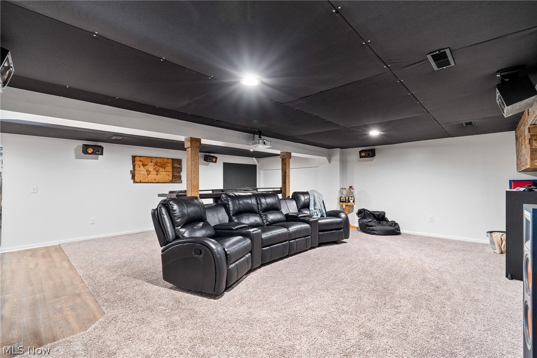 2119 Johns Road Clinton, OH 44216 - Photo 41 of 48 Spacious finished room with recessed lighting, a mixed flooring of carpet and wood-finish, and exposed wood support beams