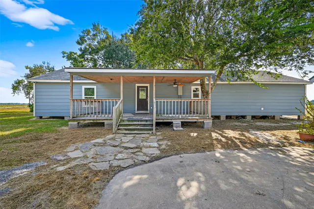 a view of a house with a yard and deck