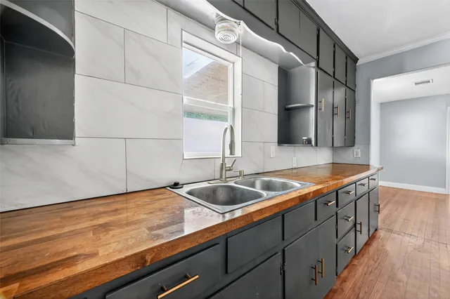 a kitchen with granite countertop a sink and cabinets