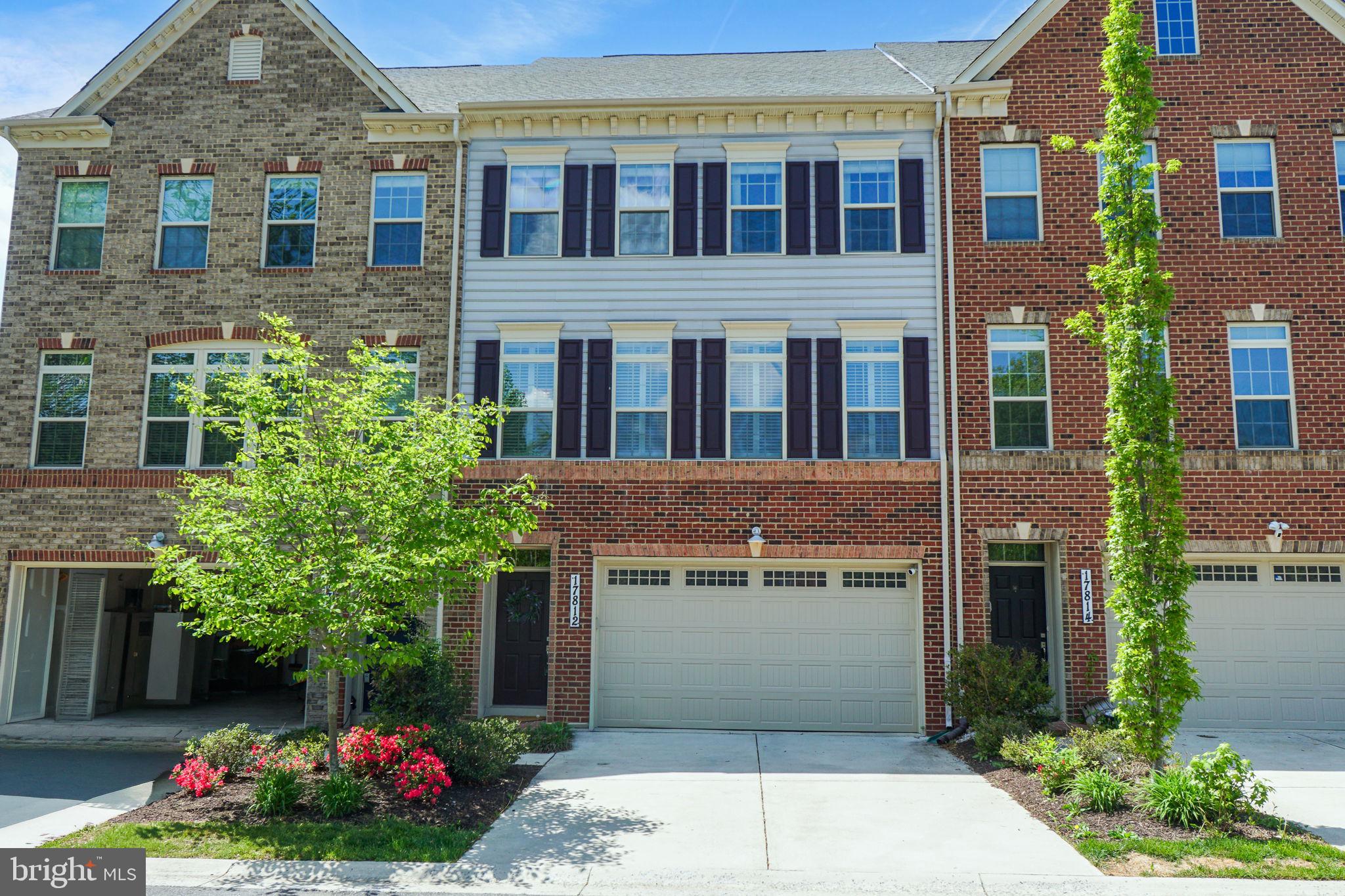 17812 Thomas Village Lane Sandy Spring, MD 20860 - Photo 2 of 37 a front view of a building with a garden