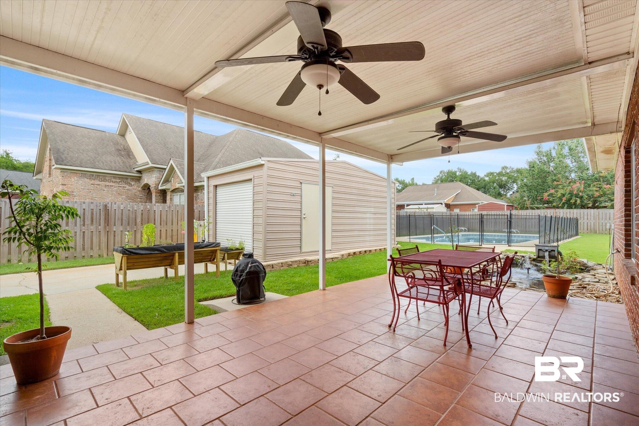 1561 William Dunn Way Mobile, AL 36695 - Photo 3 of 28 View of patio featuring a storage unit, ceiling fan, and a pool