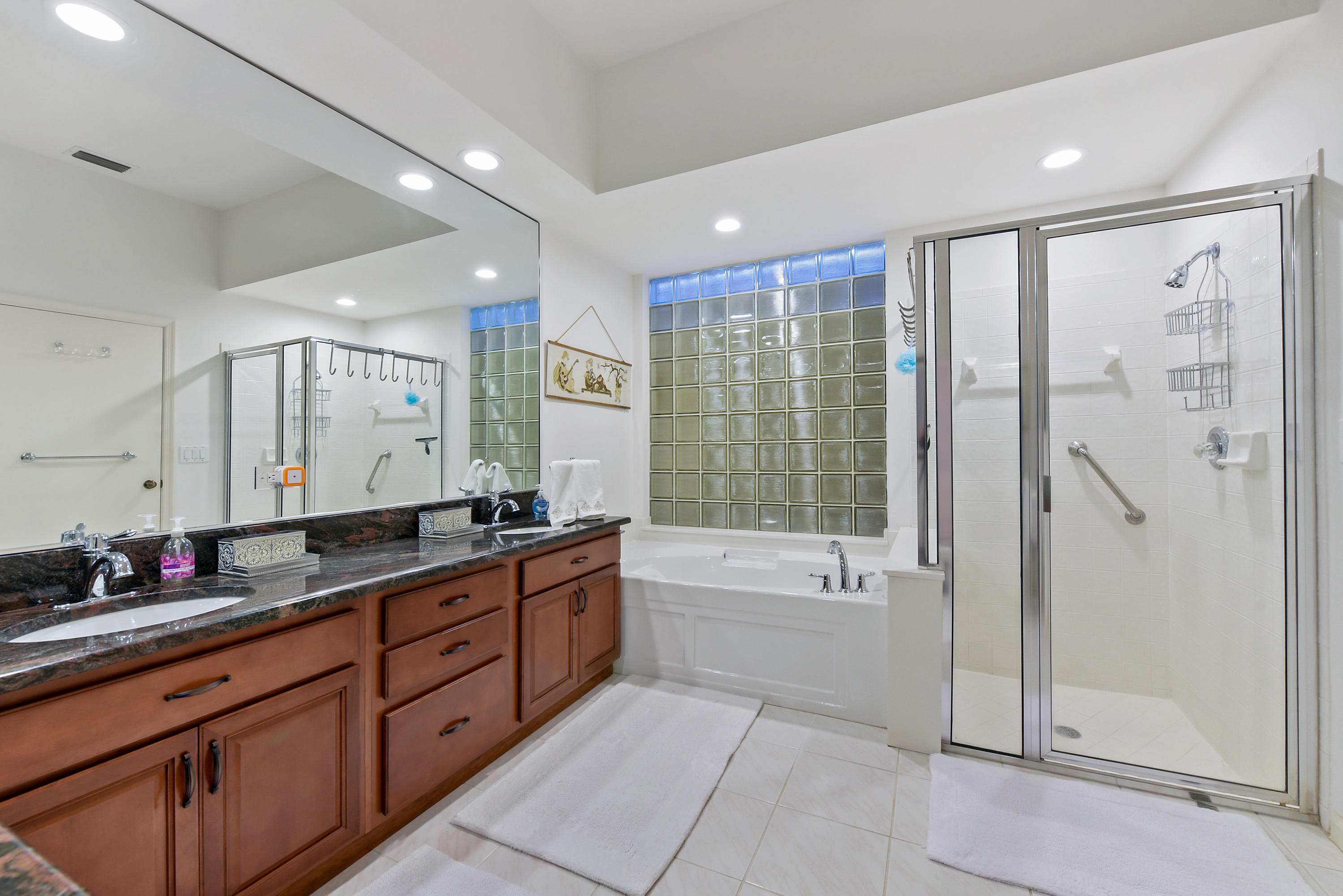 6606 Northwest 23rd Terrace Boca Raton, FL 33496 - Photo 12 of 21 a spacious bathroom with a granite countertop tub sink shower and mirror