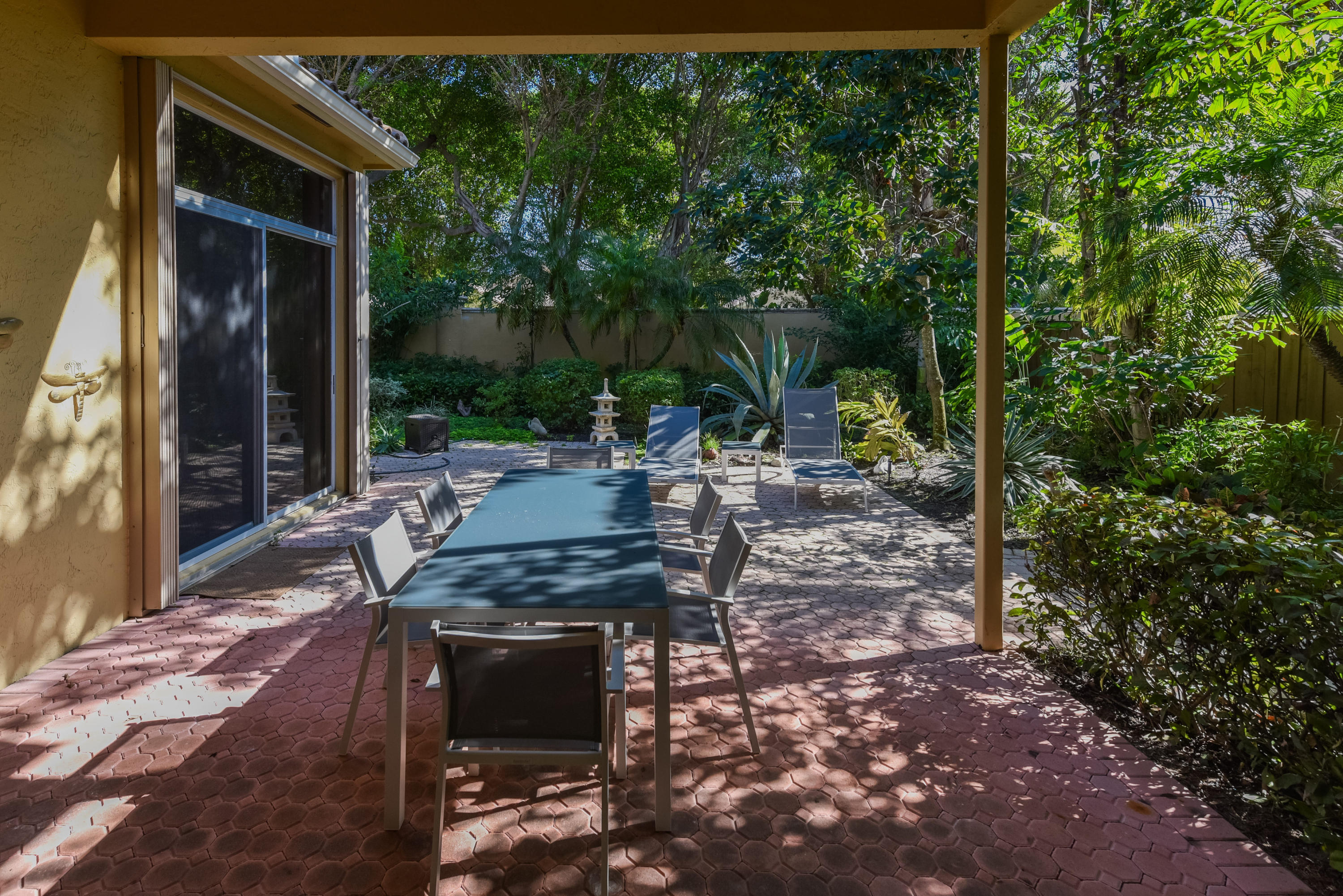 6606 Northwest 23rd Terrace Boca Raton, FL 33496 - Photo 17 of 21 a view of a patio with table and chairs with wooden floor and fence