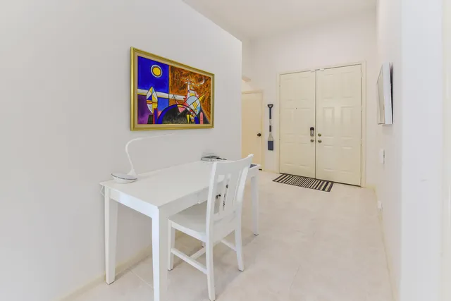 a view of a room with shelves and wooden floor
