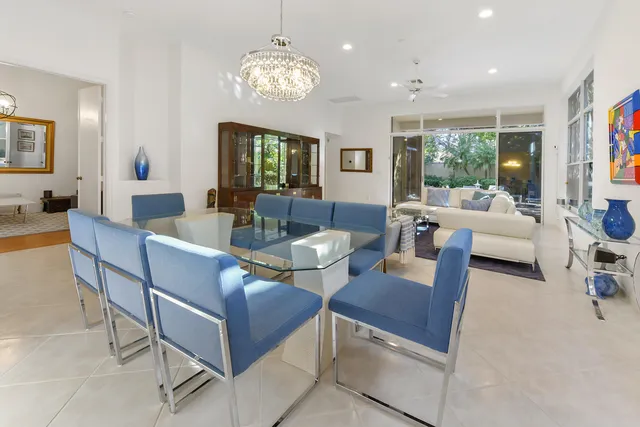 a living room with fireplace furniture and a large window or chandelier