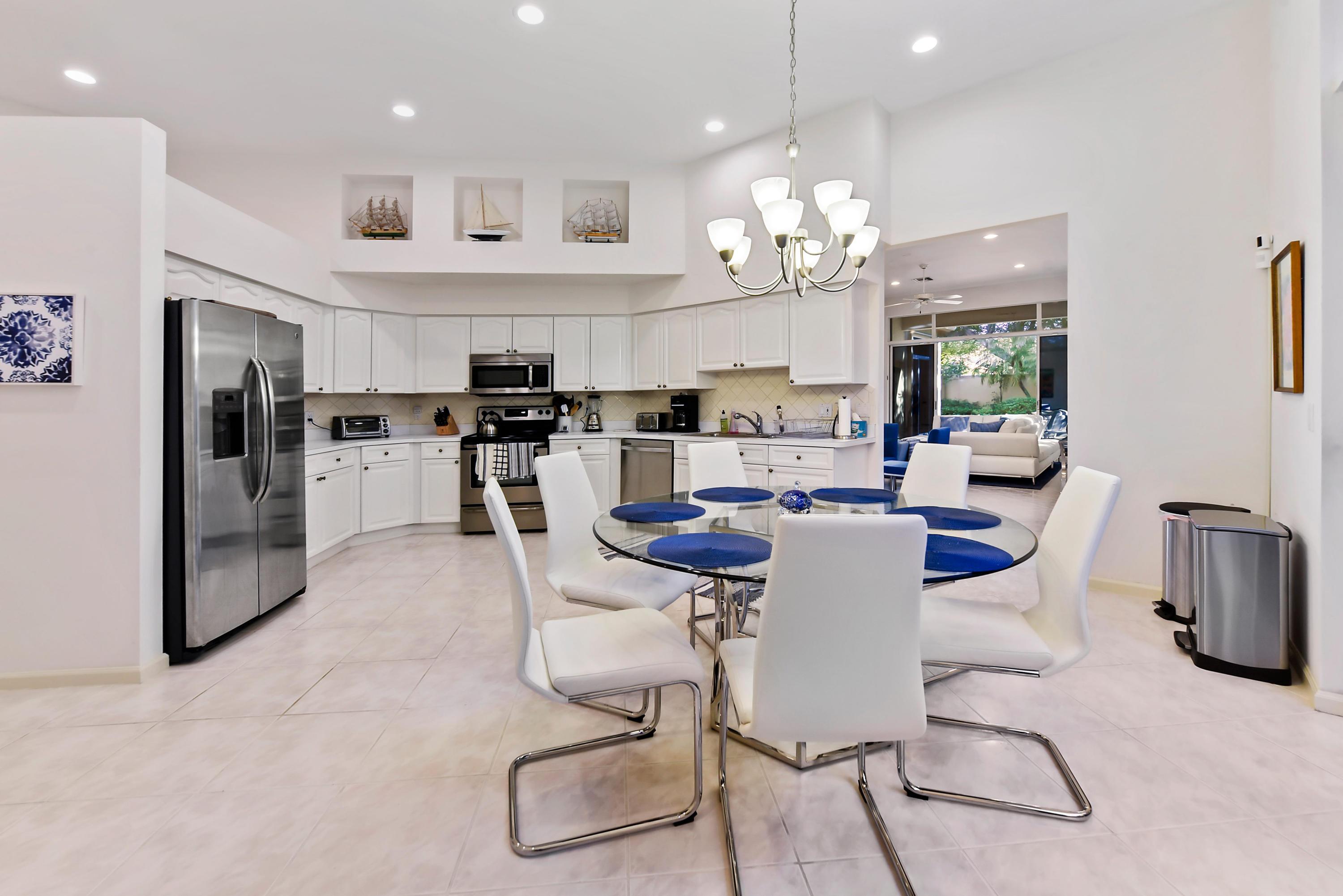 6606 Northwest 23rd Terrace Boca Raton, FL 33496 - Photo 8 of 21 a large kitchen with a table and chairs