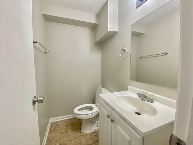 a bathroom with a sink toilet and a mirror