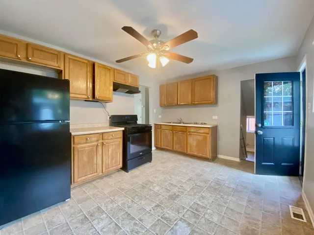 a kitchen with stainless steel appliances granite countertop a refrigerator a stove a sink dishwasher and a microwave oven