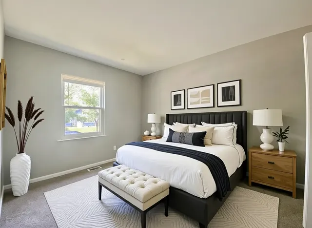 a bedroom with a bed and a couch