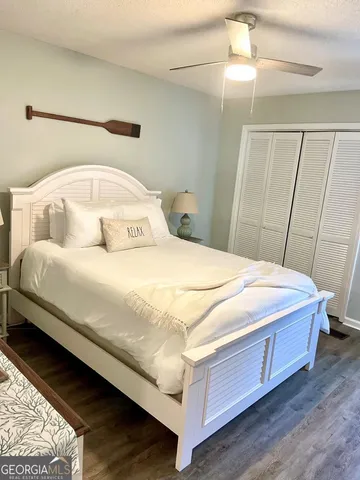a large bed sitting in a bedroom next to a window
