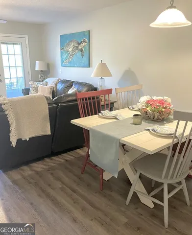 a dining room with furniture and wooden floor