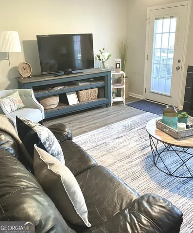 a living room with furniture and a flat screen tv