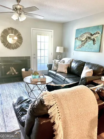 a living room with furniture and a lamp