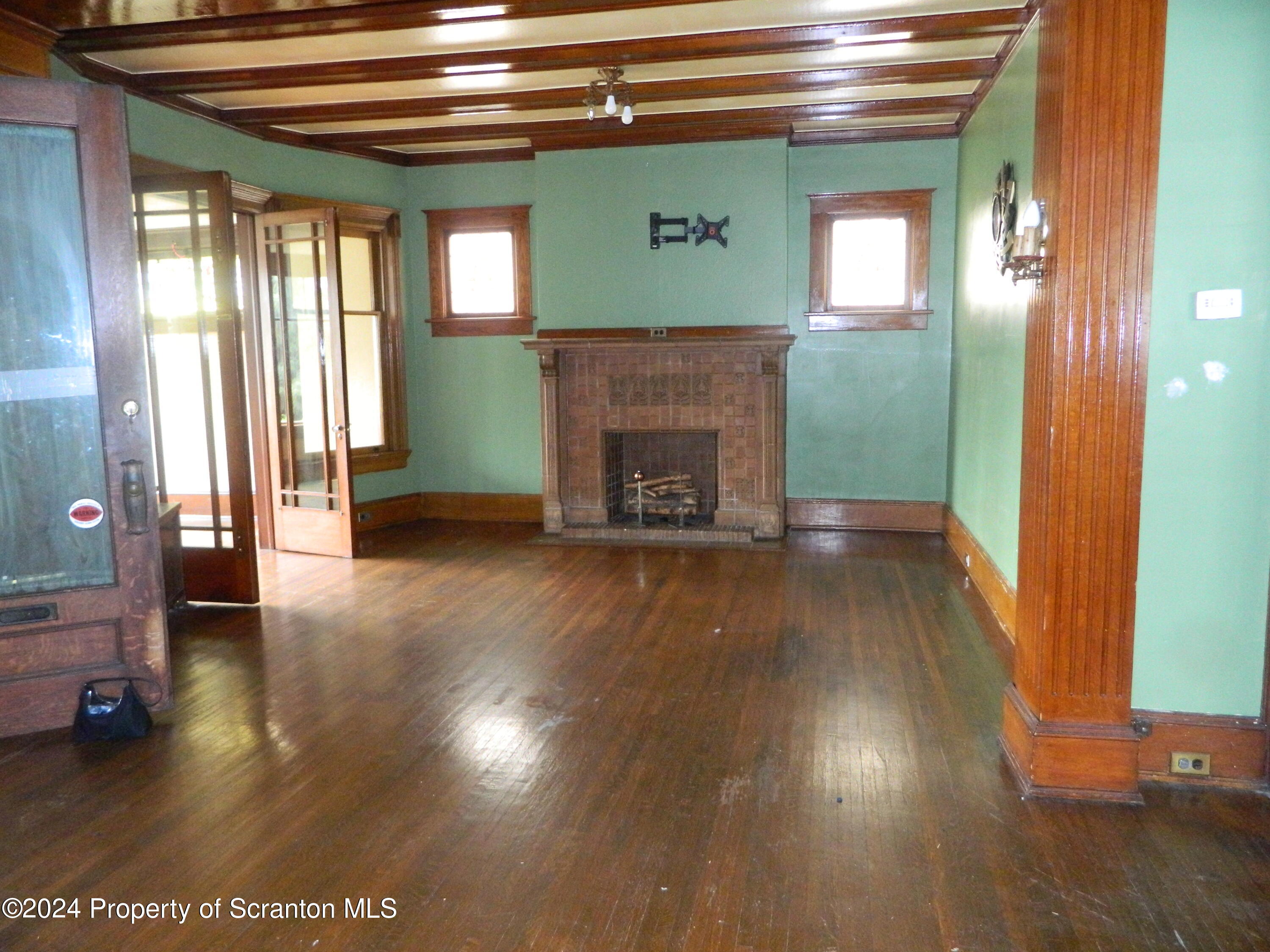 753 North Main Avenue, Unit 1 Scranton, PA 18504 - Photo 4 of 10 a view of a livingroom with wooden floor and a fireplace