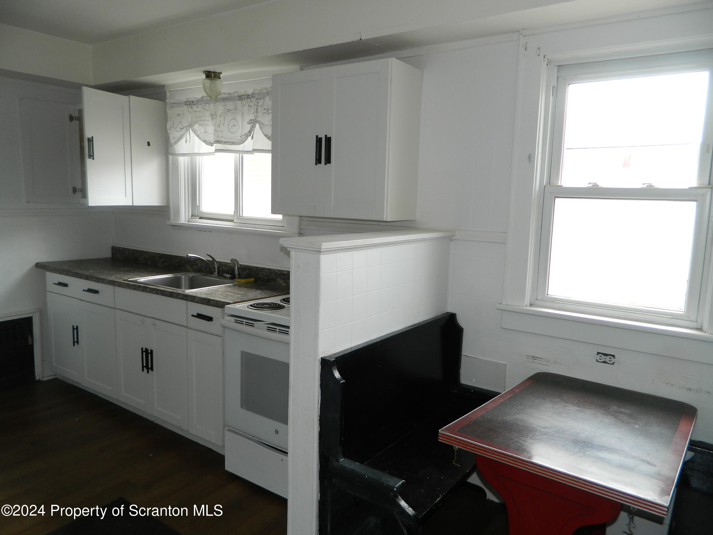 753 North Main Avenue, Unit 1 Scranton, PA 18504 - Photo 8 of 10 a kitchen with a stove cabinets and a window