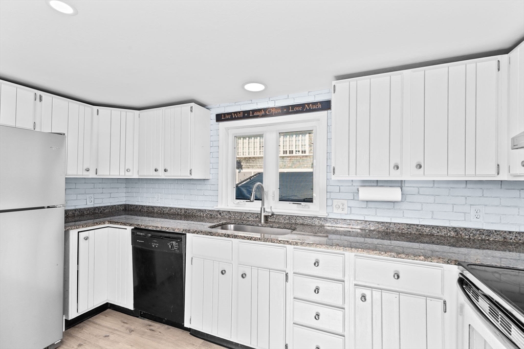 74 Cherry Street Marshfield, MA 02020 - Photo 12 of 35 a kitchen with granite countertop white cabinets and white appliances