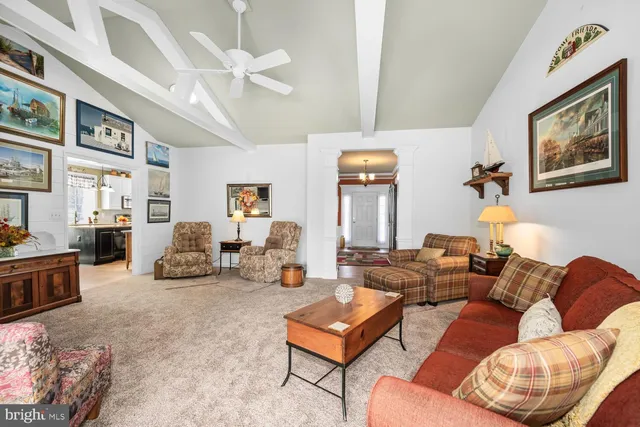 a living room with furniture ceiling fan and a rug