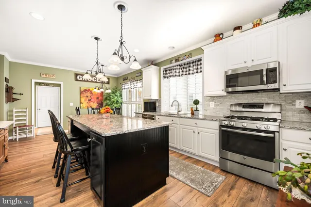 a kitchen with a stove a sink and a refrigerator