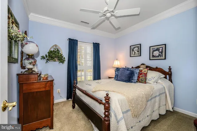 a bedroom with a bed and a potted plant